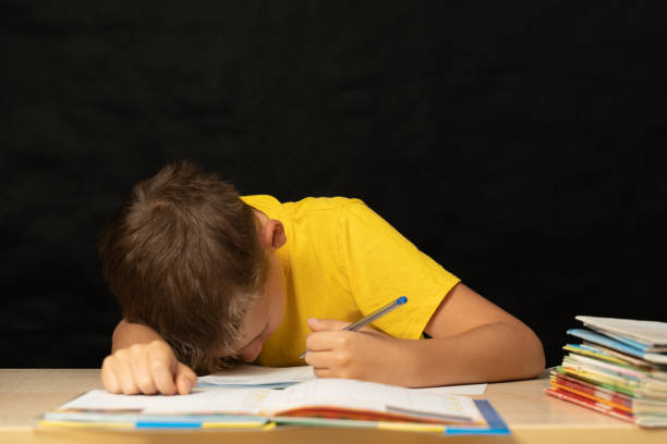 istock Schoolboy fell asleep at the table, doing his homework 1279214474