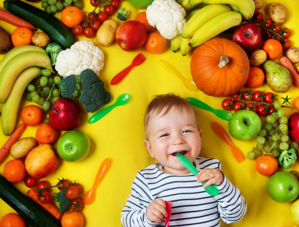 Baby surrounded with fruits and vegetables