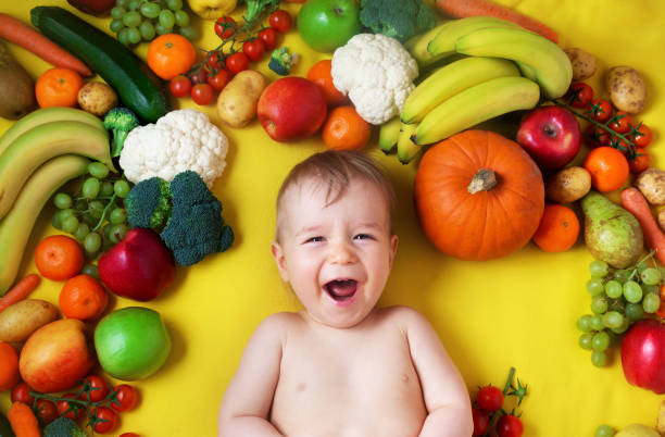 istock Baby surrounded with fruits and vegetables 1279214652