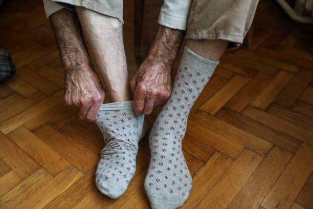 istock A hand to some action to put a sock on a foot 1279220579