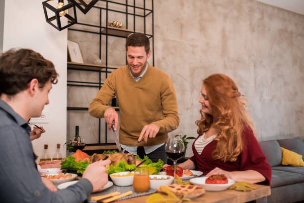 istock Man cutting a roasted turkey during the Thanksgiving dinner 1279222448