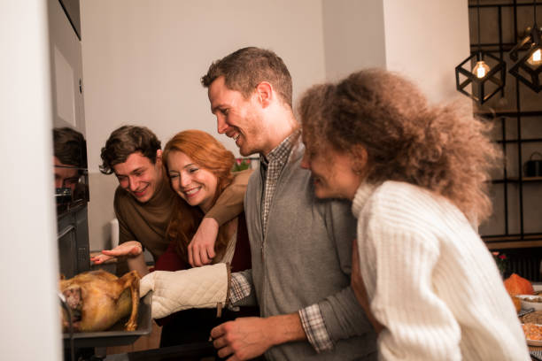 istock Parents baking a Thanksgiving turkey with their son and daughter 1279222470