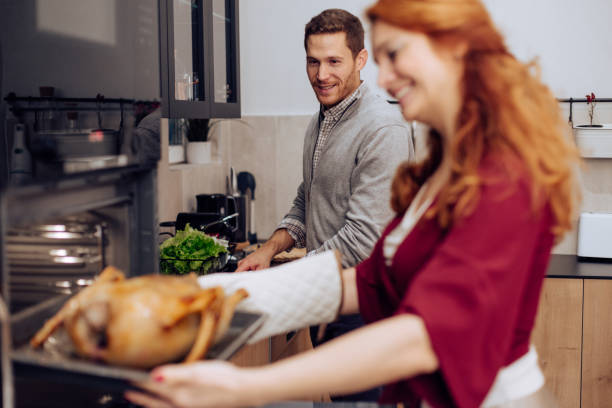 istock Woman baking a Thanksgiving turkey with her husband 1279222483