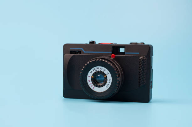 istock Old film camera on a blue background. Creative Retro Design. Trendy Vintage Accessories. Minimal flat lay. 1279222679
