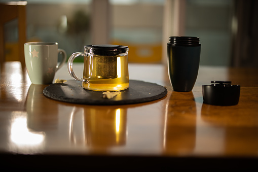 Teapot and cup on a wooden table