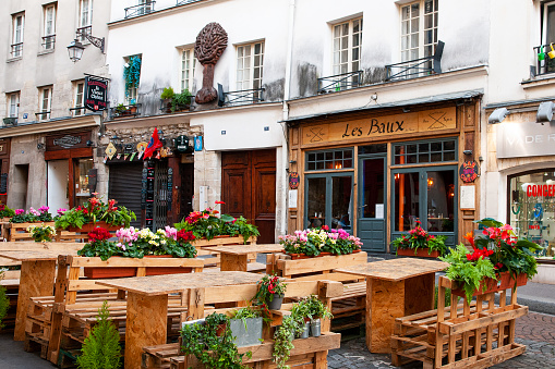 Charming parisian cafe terrace, outdoor tables, without people during pandemic Covid-19.  Rue Mouffetard in Quartier Latin, Paris, France . October 7, 2020