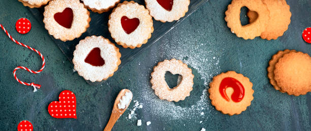 istock Top panoramic view of Christmas Linzer cookies, filled biscuits. Panoramic composition on dark wood 1279223531