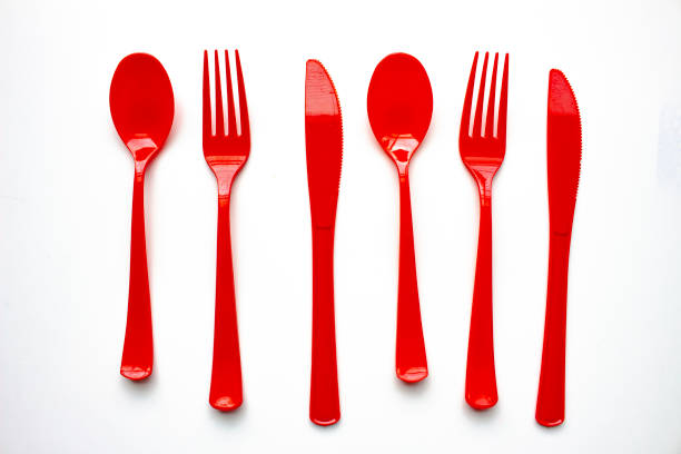 istock Single use red plastic cutlery on a white background. Concept: Ban single use plastic 1279223842