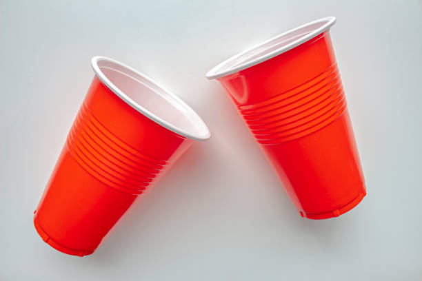 Close up to single use red plastic glass on a white background. Concept: Ban single use plastic