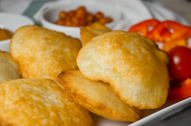 istock Indian cuisine. Luchi tortillas with cooked and fresh vegetables. 1279229451