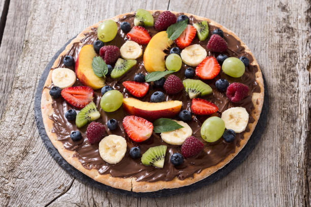 istock Fruit pizza with nut nougat cream , fruit and berries 1279231569