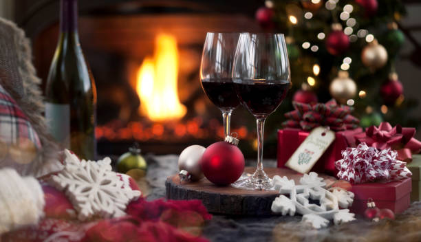 istock Christmas red wine and a gift in front of a fireplace. 1279239685