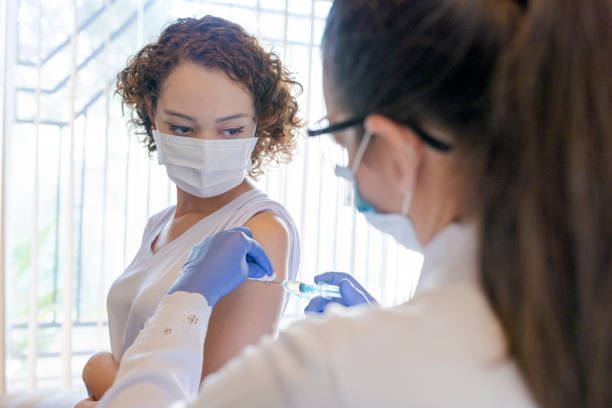 istock Doctor applying vaccine to patient 1279240460
