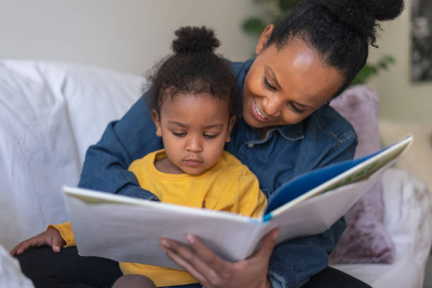 istock Mother and young son reading together on the sofa 1279240603