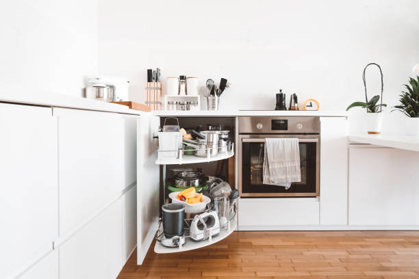 istock Full compartments of the corner cabinet in modern white kitchen 1279240805