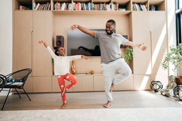 istock Dad dancing with daughter in the living room during lockdown 1279240864