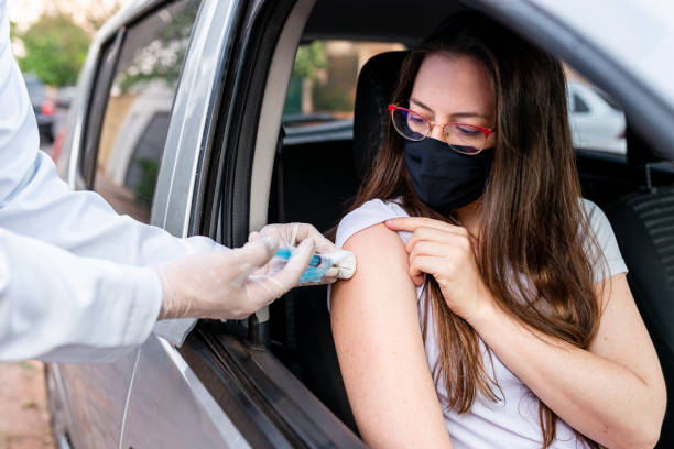 Nurse performing drive-thru immunization Nurse performing drive-thru immunization. Vaccine concept for covid-19. covid 19 vaccine photos stock pictures, royalty-free photos & images