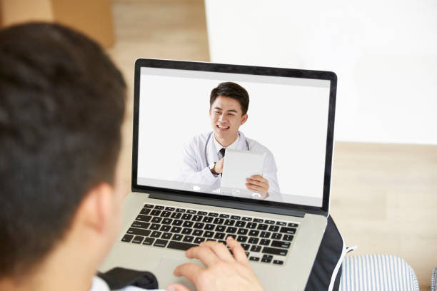 istock young asian man talking to doctor online 1279246269
