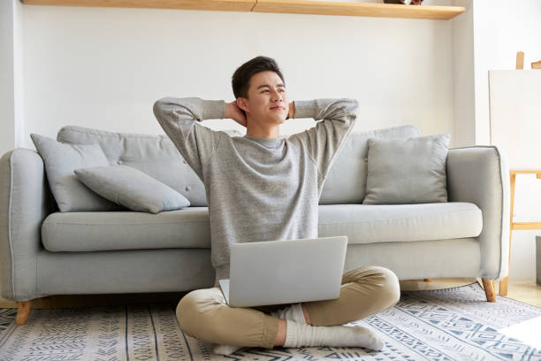 istock young asian man working at home 1279246407