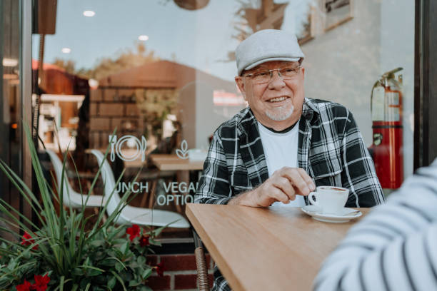 istock Elderly couple having coffee at coffee shop 1279254064