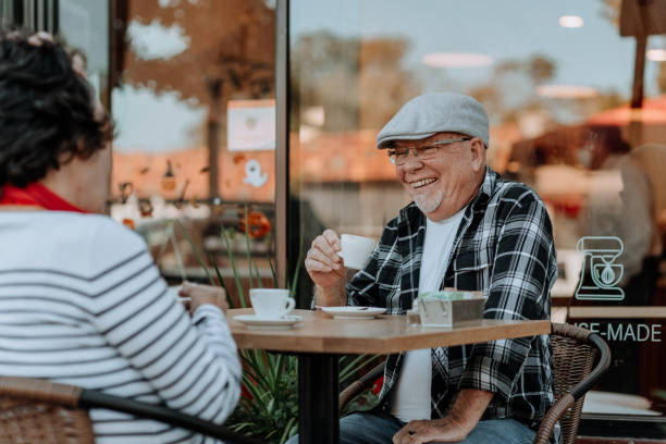 istock Elderly couple having coffee at coffee shop 1279254101