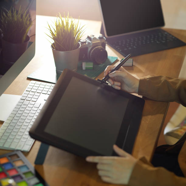 istock Female graphic designer working on drawing tablet on computer desk 1279255063