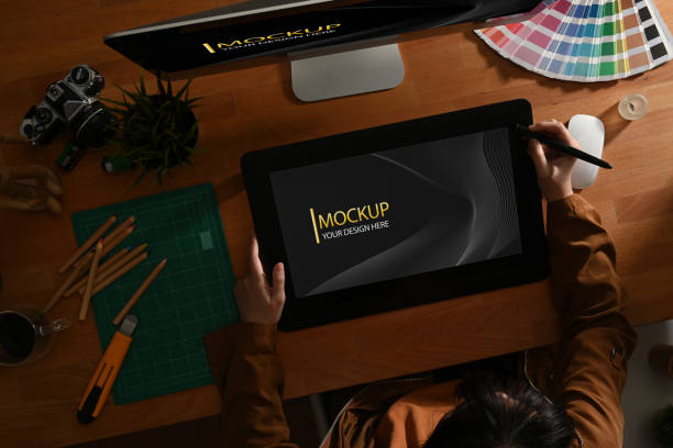 istock Female graphic designer working with mock up digital tablet on computer desk in office room 1279255073