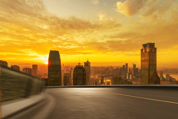 istock Motion blurred empty elevated asphalt road on bridge with modern cityscape during sunrise. 1279257039