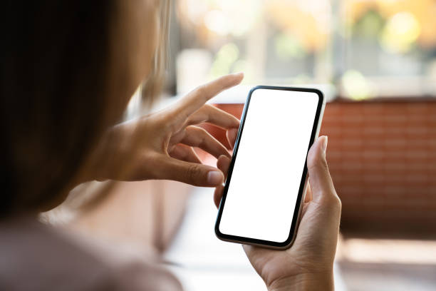 istock mock up phone in woman hand showing white screen 1279257065