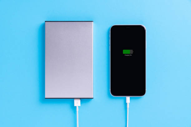 istock phone charging with external power supply on blue background 1279257091