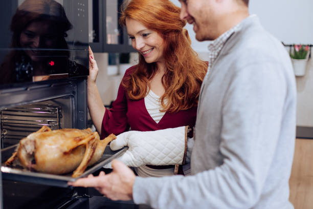 istock Woman and her husband baking a Thanksgiving turkey 1279257162