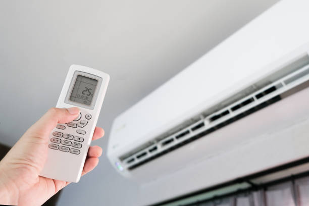 istock Man's hand using remote control open The air conditioner is cooled to 25 degrees Celsius in his bedroom. Health concepts and energy savings 1279259533