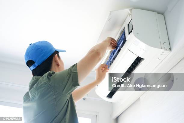 Male Repair Air Conditioner At Room He Is Air Technician Mechanic Engineer Maintenance Air Conditioner Myself Stock Photo - Download Image Now