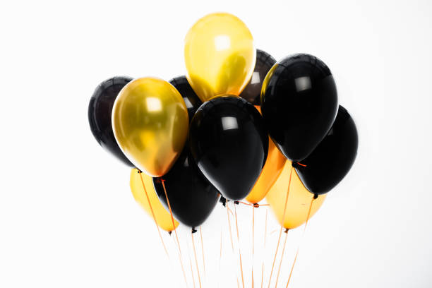 istock Festive black and golden balloons isolated on white 1279259613