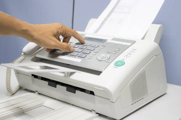 istock hand man are using a fax machine in the office, equipment for data transmission. 1279260520