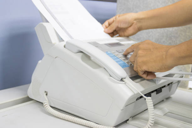 istock hand man are using a fax machine in the office, equipment for data transmission. 1279261024