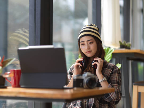 istock Female photographer with headphone relaxing with digital tablet 1279261323