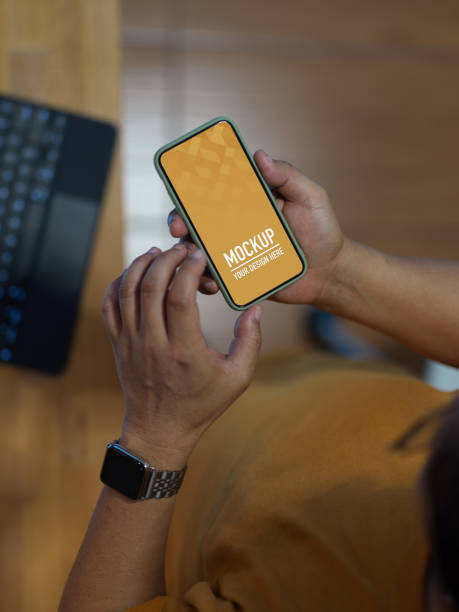 istock Male texting on mock up smartphone while sitting at workplace 1279262722