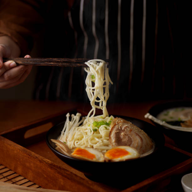 istock Female cook serving Tonkotsu ramen with pork bone based soup 1279262767
