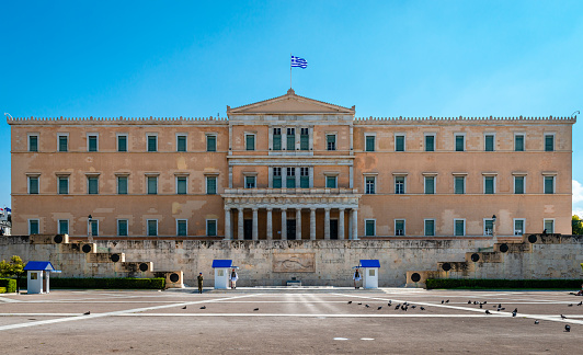 Athens / Greece - March 15 2020: View of the yard in front of the Greek Parliament, one of the most popular tourist destination. Right below the house of Parliament lays the Tomb of the Unknown Soldier.