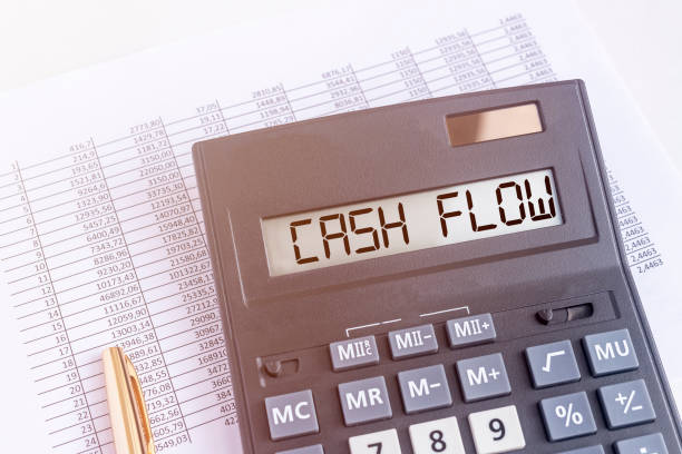 CASH FLOW word on calculator close up on financial documents CASH FLOW word on calculator close up on financial accounting documents cash flow photos stock pictures, royalty-free photos & images
