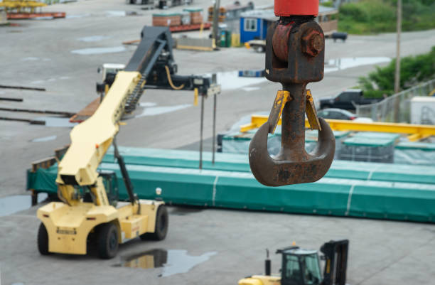 istock Cargo crane hook on a background of harbour ship port. Selective focus. 1279267259