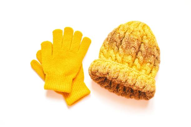 Bright yellow accessories for fall and winter season. Woolen gloves and knitted hat. Flat lay photography women's clothes Bright yellow accessories for fall and winter season. Woolen gloves and knitted hat. Flat lay photography women's clothes Knitted Gloves stock pictures, royalty-free photos & images