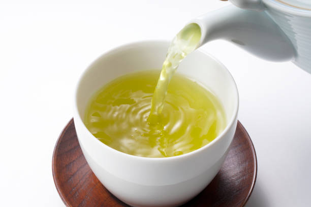 istock Pouring green tea into a teacup. Japanese green tea image 1279267719