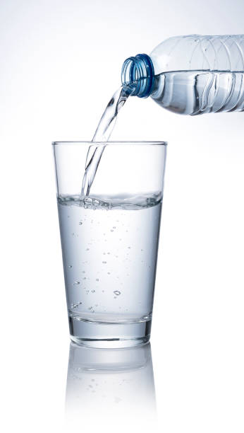istock Pour bottled water into a clear glass placed on a white background. 1279268237