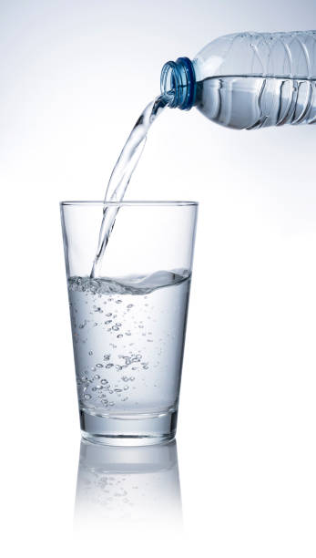istock Pour bottled water into a clear glass placed on a white background. 1279268249