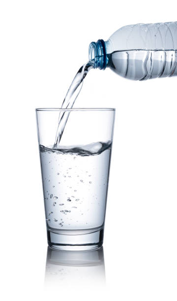 istock Pour bottled water into a clear glass placed on a white background. 1279268291
