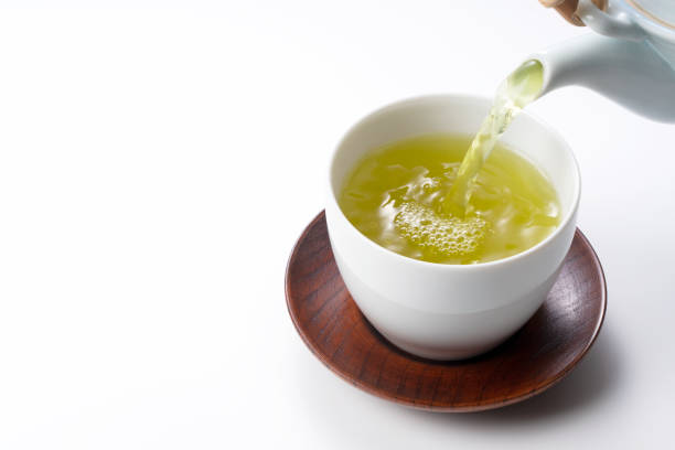 istock Pouring green tea into a teacup. Japanese green tea image 1279268467