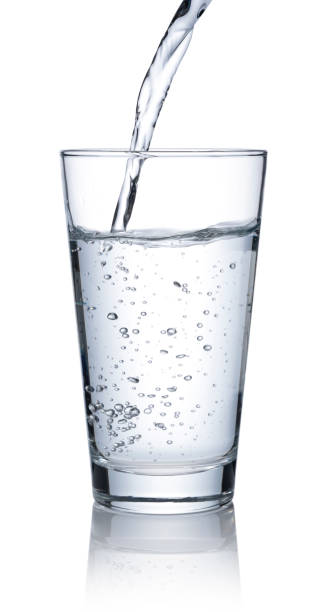 istock Pour water into a clear glass placed on a white background. 1279268504