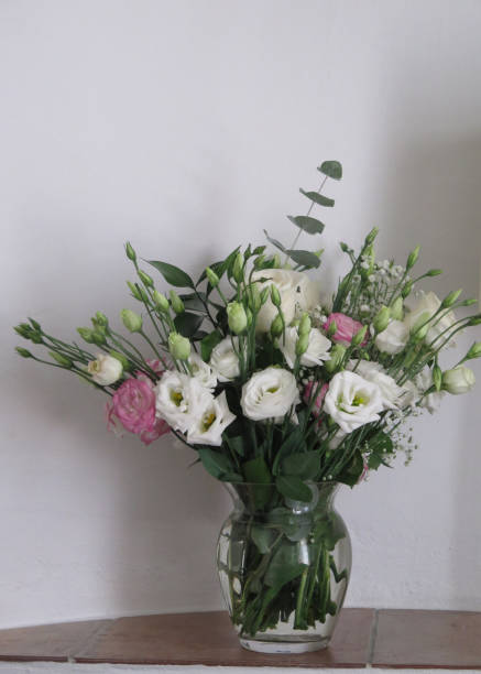 istock Wall recess with vase of white roses 1279268756